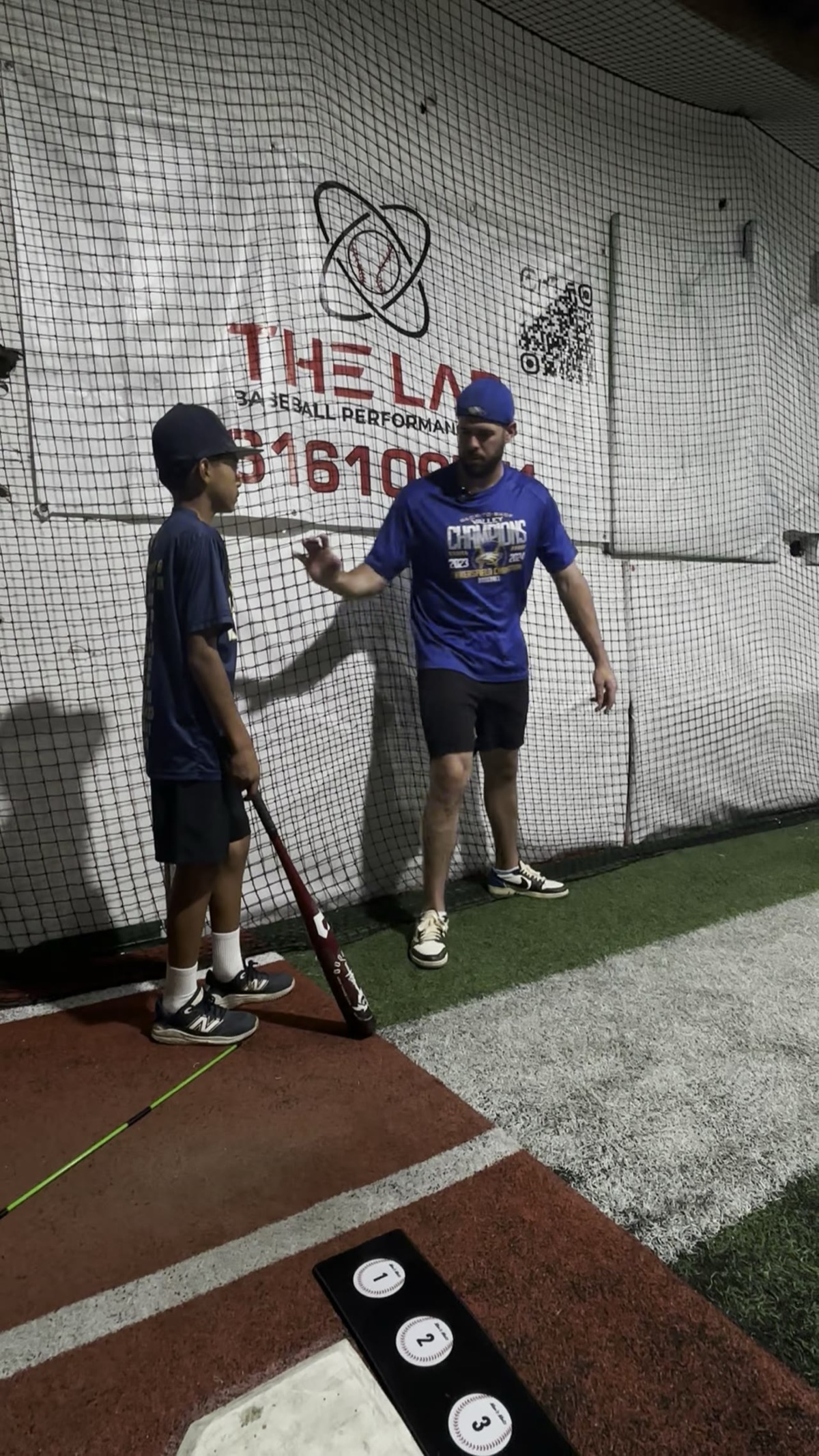 Coach working with young athlete at The Lab