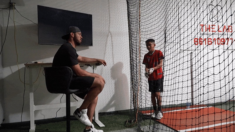 In-Person Hitting session at The Lab — coach reviewing data with player