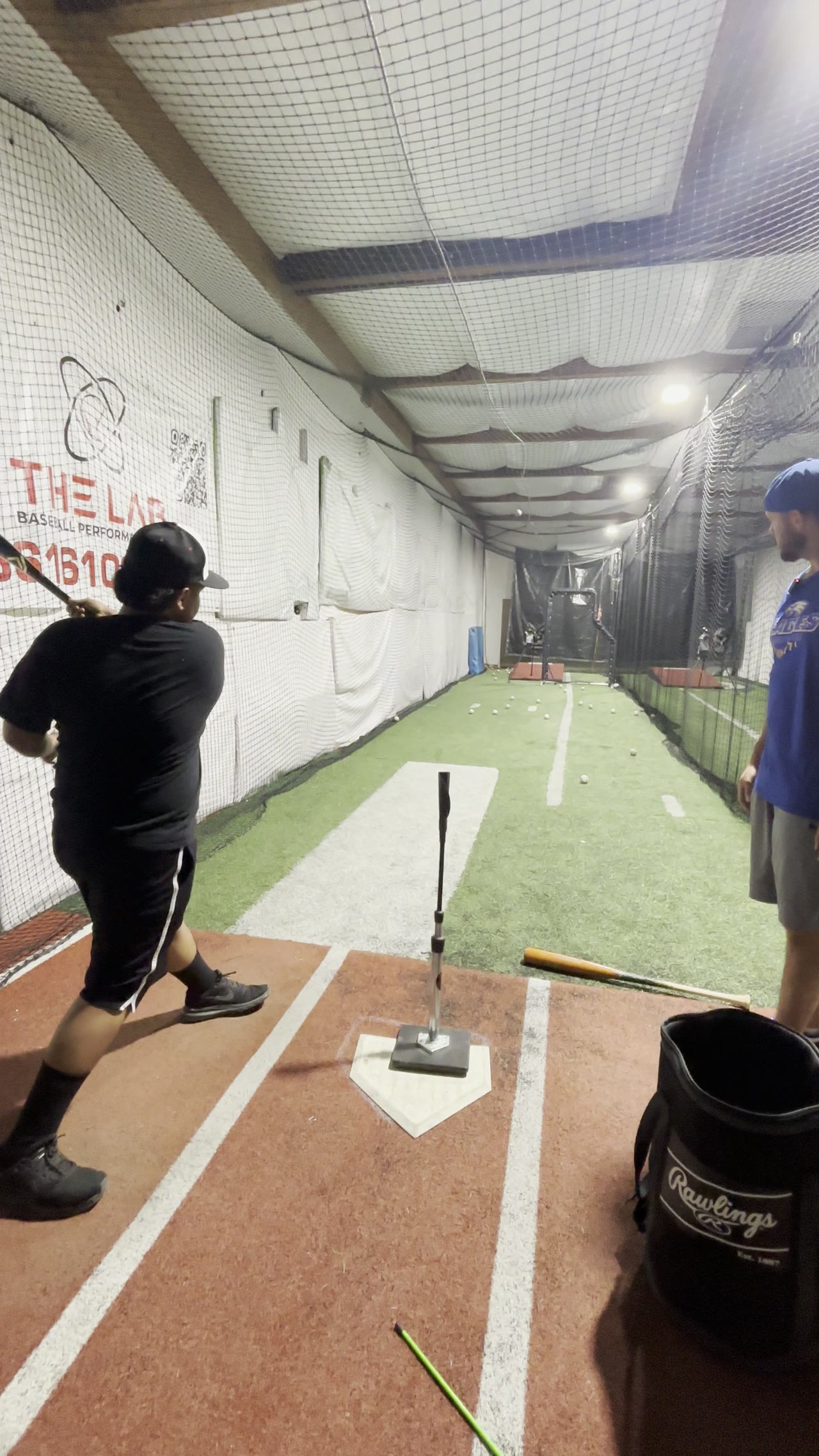 Player taking swings in the batting tunnel